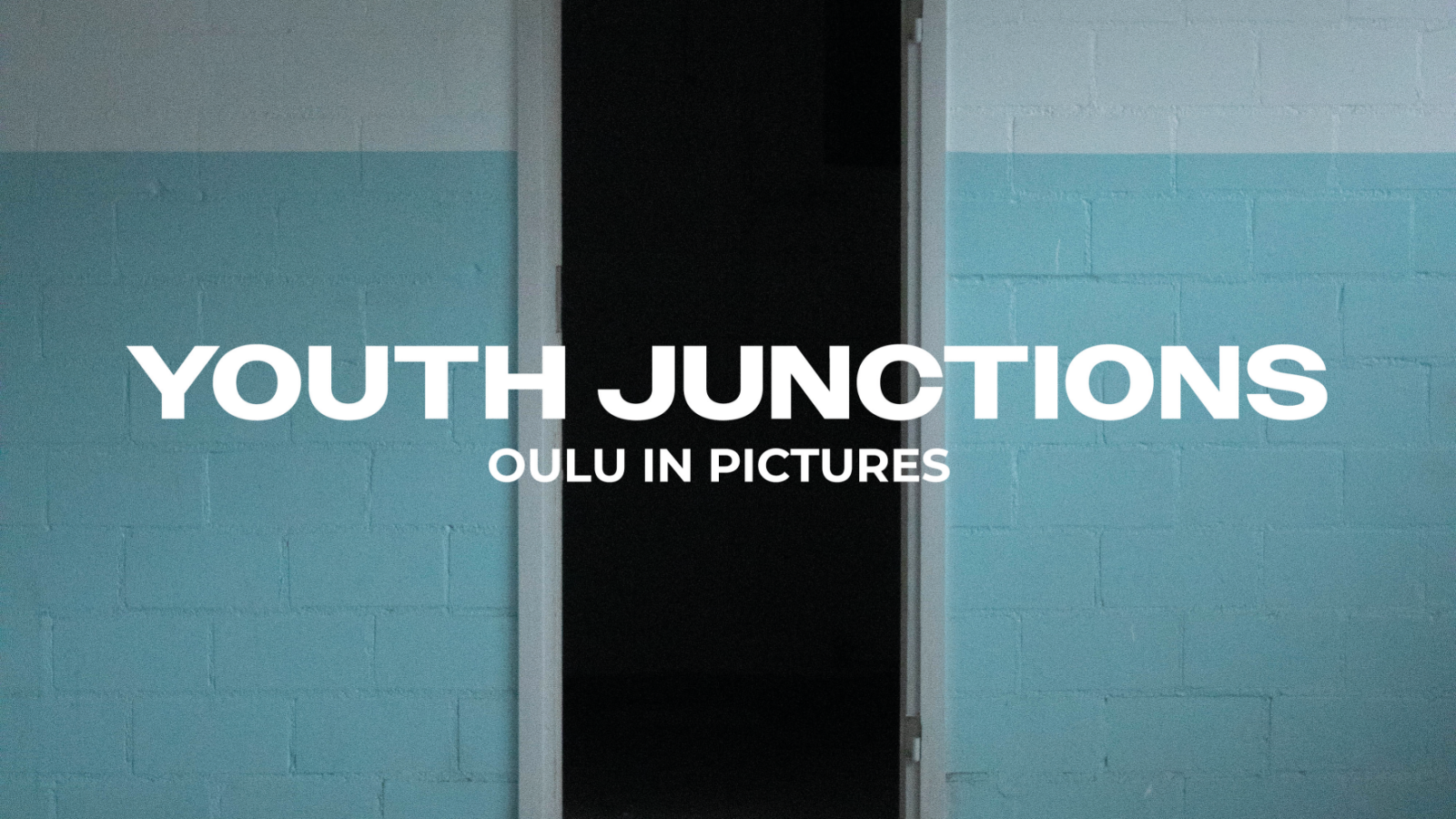 Dark door frame with white and light blue tiles. Text in picture: Youth junctions - Oulu in pictures.